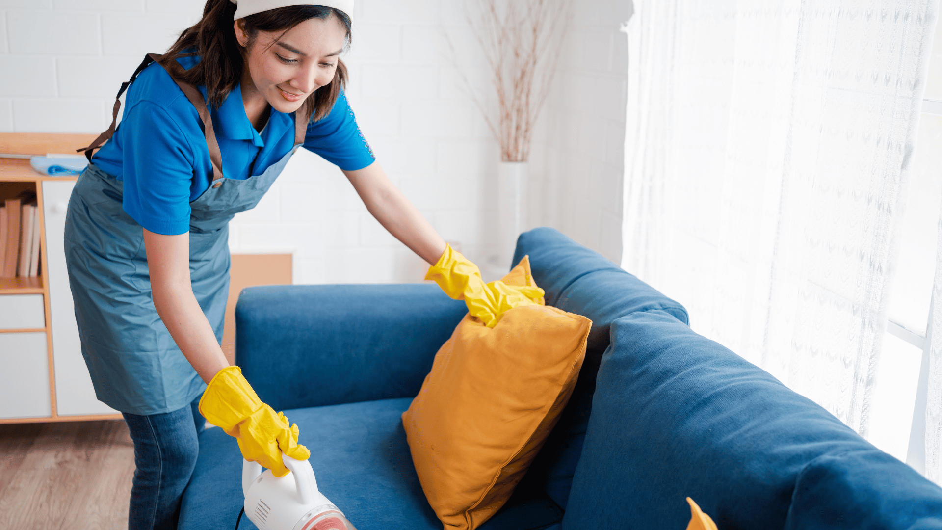 Cleaner vacuuming couch during move-out cleaning service by 302CleanIt in New Castle County DE