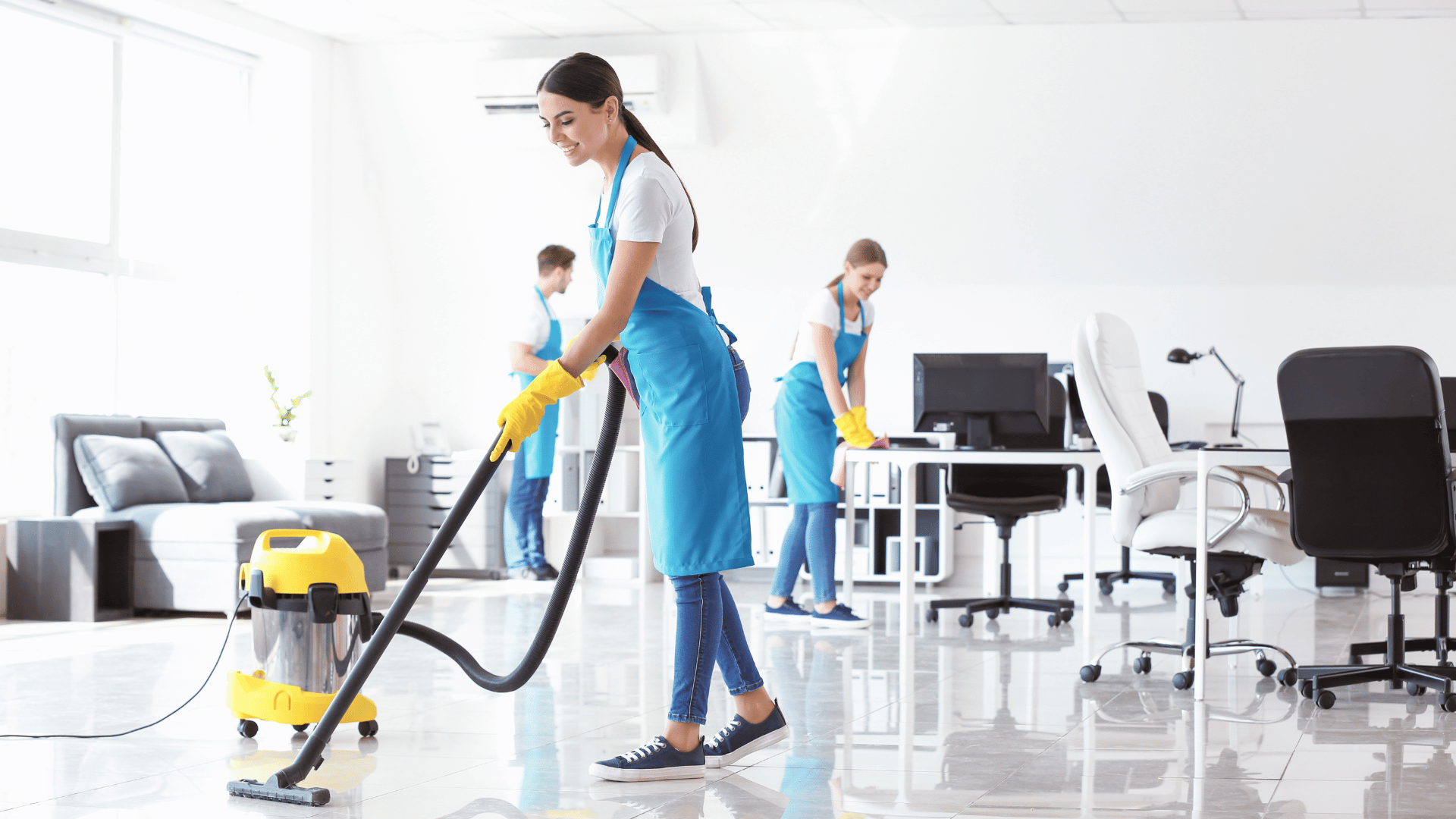 Office cleaning team vacuuming and sanitizing workspaces for businesses in New Castle County DE